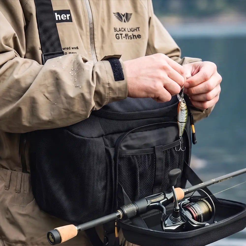 An angler tying on a lure over the folded-down tray of the ArcPro EVA sling pack